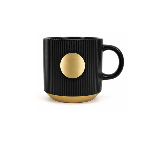 A ceramic coffee mug in black with a bronze medal accent and ribbed texture. Features a handle and a logo.