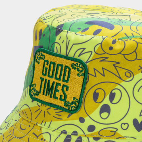 A vibrant yellow and green bucket hat featuring various playful patterns and an embroidered patch.
