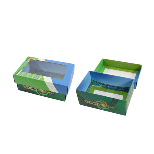 A custom gift box in blue and green with a windowed removable lid, featuring tennis-themed design elements.