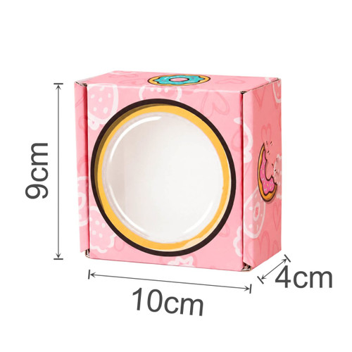 A pink custom gift box with a round window, measuring 9cm high, 10cm wide, and 4cm deep, featuring playful designs.