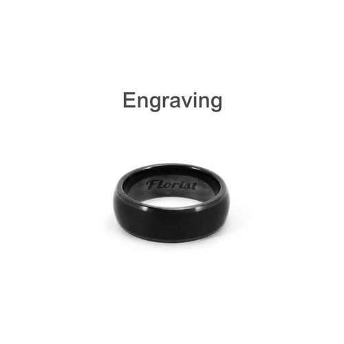 A black carbon fibre ring featuring an engraved design. The ring has a smooth, polished surface and a rounded profile.