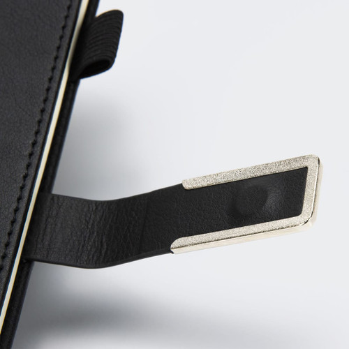 A black diary with a silver metal tab and textured cover, featuring a brand logo.