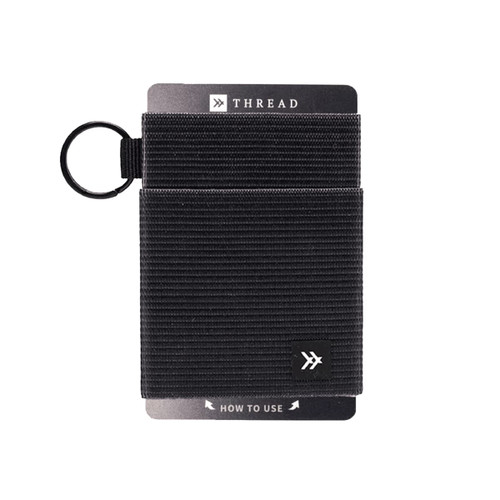 A black Thread Elastic Wallet features a textured design and includes a keyring attachment. It has a branding logo.