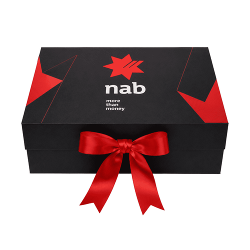 A small black magnetic gift box featuring a red ribbon and a logo on the front.