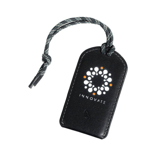 A black luggage tag with a textured finish and a cord, featuring a logo on the front.