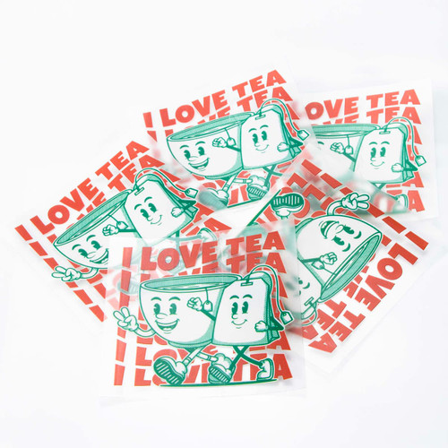 A collection of stickers featuring a cartoon teacup character and the phrase "I love tea" in red and green colours.