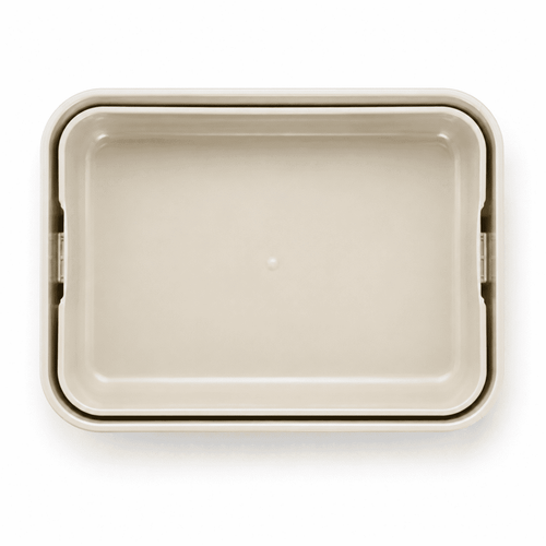 A light beige rectangular lunchbox with a smooth surface and rounded edges. It features a logo.
