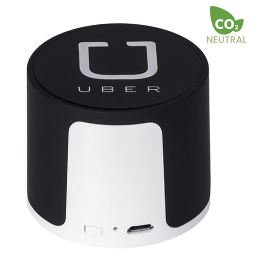 A black and white wireless speaker featuring a logo and a USB port. The design is cylindrical and compact.