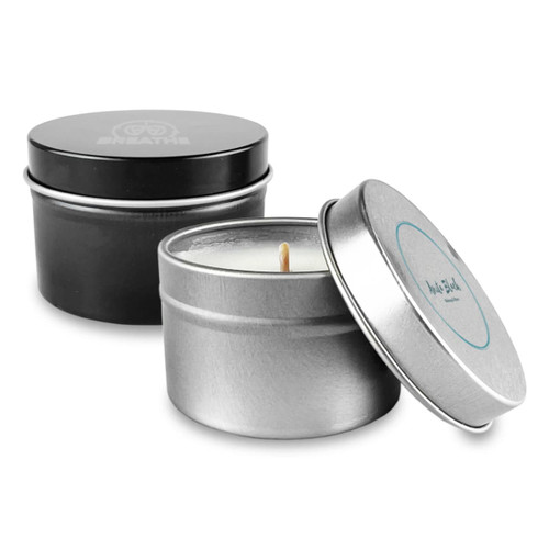 A tin candle set featuring a silver and black container with a visible wick. Both tins have different designs.