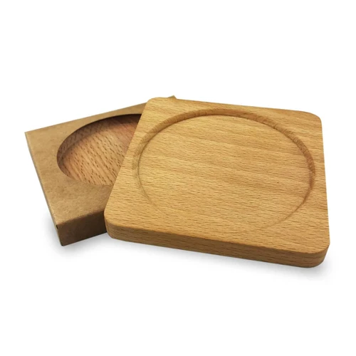 A wooden coaster in natural timber finish, featuring a circular indent, resting on a flat surface.