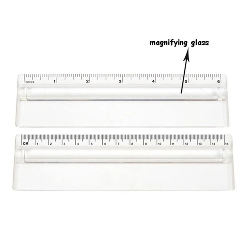 A transparent 15cm ruler featuring a magnifying glass, with clear measurement markings in centimetres and inches.