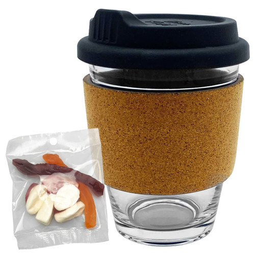 A glass coffee cup with a cork band, accompanied by a mixed bag of colourful jelly lollies.