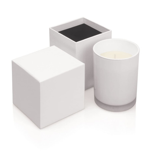 Three candles of varying designs: a white cylinder candle and two square candles, one black and one white.