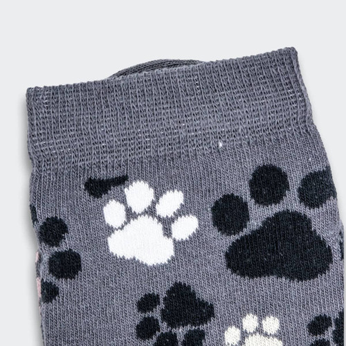 Grey knitted kids' socks featuring a playful pattern of black and white paw prints.