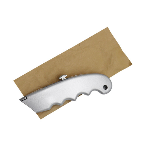 A silver cutter with a textured handle resting on a piece of brown paper. The item has a brand logo.