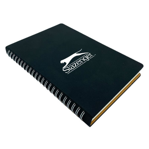 A black spiral notebook with a logo on the front and yellow edges.