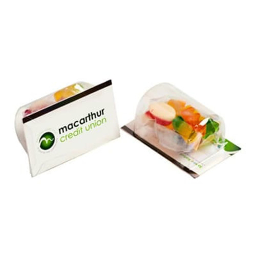 A clear package containing mixed lollies, with a card featuring a logo. The lollies are colourful and assorted.