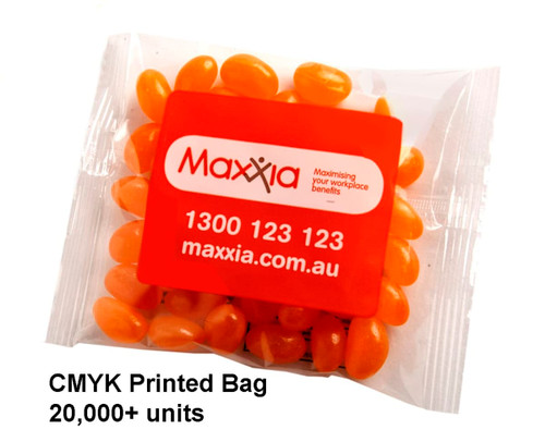 A clear bag containing orange jelly beans, with a logo on the packaging.