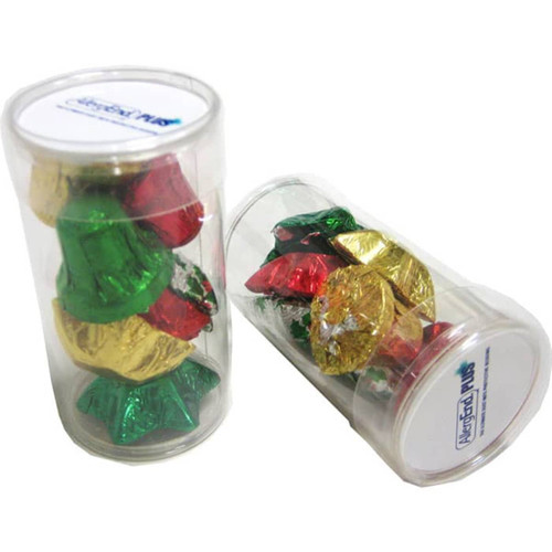 A clear tube filled with wrapped chocolates in red, green, and gold shapes resembling Christmas bells.