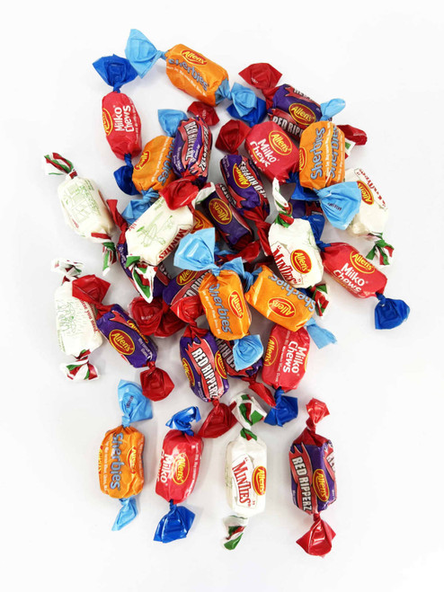 A collection of colourful mixed lollies in various wrappers, featuring blue, red, and white designs, with a logo present.