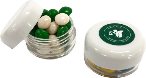 A small screw cap jar filled with green and white chewy fruit candies, featuring a branded lid.