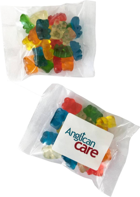 A pack of colourful gummi bears in various shapes, contained in a clear plastic wrapper with a logo.