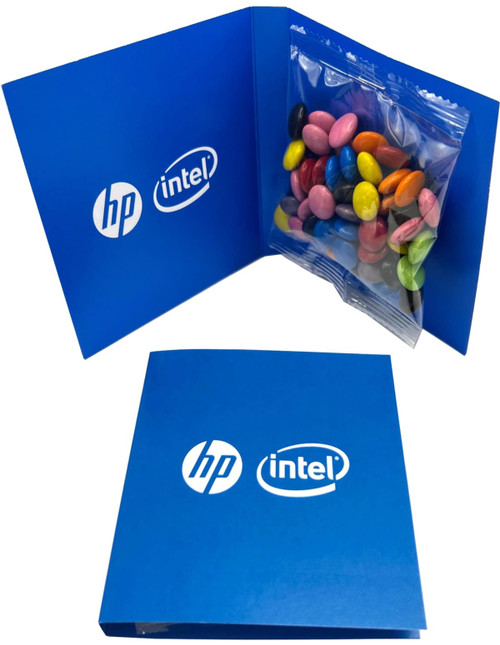 A blue promotional card containing a bag of colourful chocolate beans. Features logos on the card.