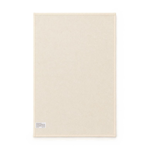 A medium cotton tea towel in a cream colour, featuring a small tag and a simple, plain design.