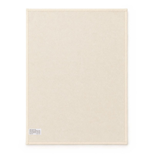 A large cream cotton tea towel featuring a plain design and a small label in one corner.