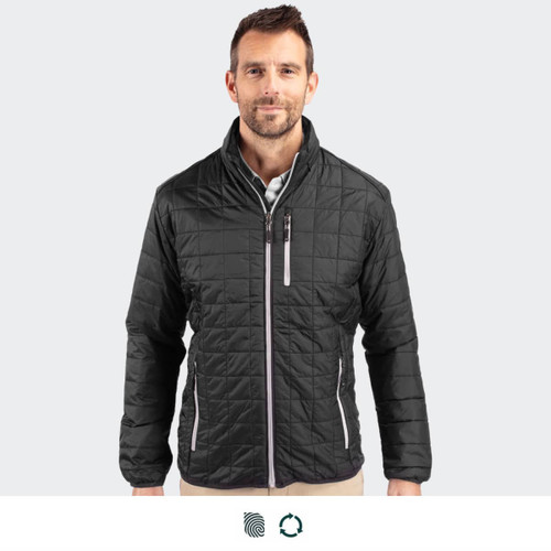 A black Cutter & Buck Rainier men's jacket featured on a model. The jacket has a quilted design and a front zipper.