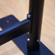 A close-up of a black metal frame with a joint detail, designed for a sidewalk cafe barrier.