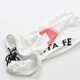 A white car mirror cover with a drawstring, featuring a red and black logo.