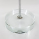 A clear circular base with a metal rod, designed for displaying desk flags.