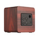 A square speaker with a wood-like finish, featuring control buttons and a USB port. It has a minimalist design.