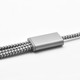 A charging cable with a silver metal connector and a braided grey and black design, featuring a logo.