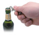 A drink bottle being opened with a silver DIY keyring bottle opener held by a hand. The bottle has a green glass body.