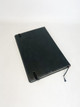A5 notebook with 240 pages, featuring a black leather cover and white stitching along the edges.