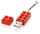 A red USB drive shaped like a Lego brick, with a removable top piece and a keychain loop.