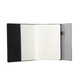 A large B5 notebook featuring a black koeskin cover with pockets and blank pages.