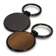 A round key ring featuring a black metal finish and a wooden side, with a logo present on the metal part.