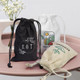 Three small cotton gift bags in black, white, and natural colour, featuring various designs and drawstring closures.