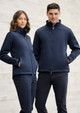 A navy softshell jacket featuring zip pockets and a high collar, worn by a man and a woman. The image has a subtle background.