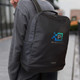 A black Moleskine Ripstop Backpack with a logo, worn on a person's back, featuring a sleek design and sturdy handle.