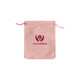 A pink velvet drawstring bag with a logo printed on the front. The bag has matching pink drawstrings.