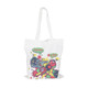 A white cotton tote bag featuring a colourful graphic design and long handles, along with a logo.
