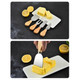 A cheese board set with four stainless steel knives featuring wooden handles, displayed with butter and lemons on a white plate.