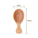 A small bamboo hairbrush featuring a wooden body and orange bristles, measuring 6cm by 14cm.