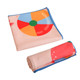 A microfibre beach towel in pastel colours, featuring a beach ball design, folded and rolled for compact storage.