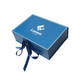 A blue custom gift box with a white logo and a decorative ribbon. The box features a sleek design.