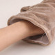 A plush hippopotamus hand puppet in a soft brown colour, with a hand inside ready to animate it.